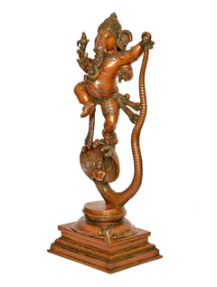 Brass Ganesha dancing idol on Shesha serpent coil, raised on stepped pedestal