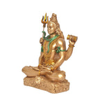 Side view Shiva idol seated in blessing pose with trident, green necklace details