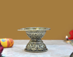 Brass aarti diya oil lamp, three-quarter view with detailed side engravings