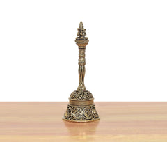 Bronze pooja bell with Garun figure; slender stem with carved bands and base.