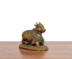 Seated Nandi brass figurine with ornate teal-gold patterns and detailed face