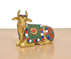Brass seated Nandi figurine with painted jewelry motifs on side blanket