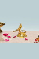 Gold metal parrot diya statue with lit candle on round base, 4 inches