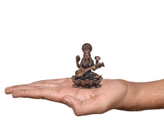 Small Copper Maa Saraswati idol on open hand, seated with veena and lotus base