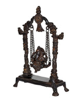 Brass Ganesha swing idol statue, side view of chained seat and carved support frame