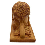 Hand-carved kadamba wood Buddha figurine from behind, textured head and draped robe