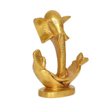 Brass-style Ganesha statue idol, angled view showing trunk and hands around the base
