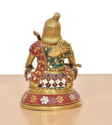 Brass Ram Lala statue from back/side, jeweled blouse and maroon patterned skirt on base