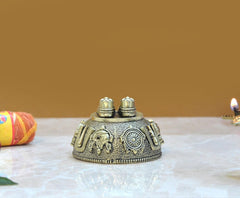 Brass charan paduka idol, opposite side view with wheel motifs and side figures