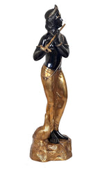 Brass Krishna idol with flute, profile view, black upper body and gold lower attire
