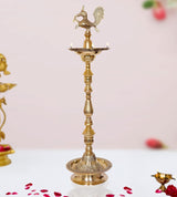 Brass diya lamp stand with peacock figure and twin-flame saucer, tall 42 in
