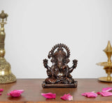 Small sitting Lord Ganesha brass idol with ornate crown and four raised arms