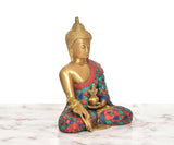 Brass Buddha statue, seated on base, multicolor patterned robe with hand gesture