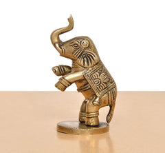 Brass elephant figurine, 4 in, gold tone, front 3/4 view, raised trunk, patterned armor