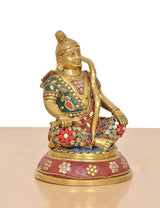 Brass Ram Lala seated statue, angled view with colorful shoulder drape and jeweled waist