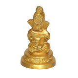 Golden Ganesha idol statue, close view of head and torso with pedestal base