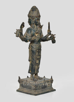 Three-quarter view four-armed Vishnu statue in blue-green bronze on raised pedestal