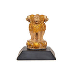 Front view golden lion resin figurine on black base with raised circular emblem