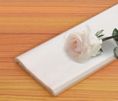 Transparent wrapping sheet with white rose and green stems in one corner