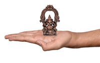 Copper Ganesha idol statue shown on palm, 4 inch height