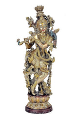 Standing brass Krishna idol playing flute with raised arms and ornate layered ornaments