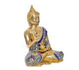 Brass Buddha idol in Abhaya mudra, seated on base, blue-and-gold patterned cloth