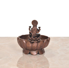 Copper Lakshmi Maa urli bowl from back view, goddess icon on finial
