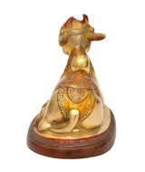 Brass Nandi bull figurine, back-facing view with detailed ornamented drape and base
