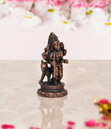 Copper Kal Bhairav idol, angled view, raised crown and holding weapons