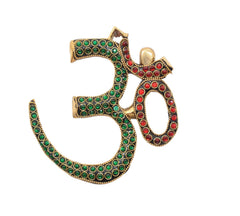 OM wall sculpture in brass with green stones and red circular accents