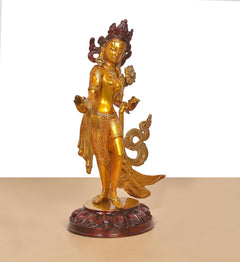Brass Tara Devi dancing statue, front view, crowned figure with fan-like ornament