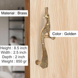 Golden brass peacock door handle pair on light wood, ornate textured body; 8.5 in height
