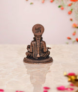 Annapurna copper idol, rear view with round emblem on the head and seated base