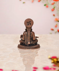 Annapurna copper idol, rear view with round emblem on the head and seated base