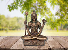 Shiva murti figurine holding trident and small drum, seated on detailed lotus base