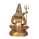 Brass Shiva back view, long hair and trident beside seated meditating figure on carved base