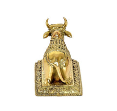 Back view Nandi cow idol statue with trident horns on decorated base