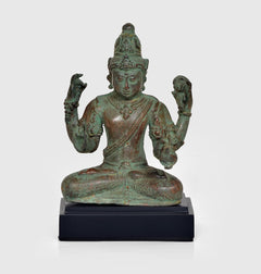 Vintage bronze Lord Vishnu statue, seated with four arms raised, on dark wooden base