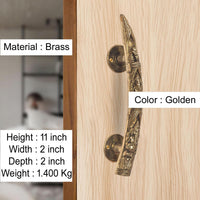 Golden brass Ganesha door handle pair on light wood door, round rosettes, 11 in height