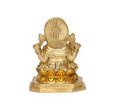 Brass Ganesha idol, back view, helmet-like crown and raised details on pedestal