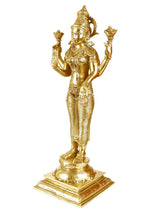 Brass Lakshmi statue, side view, four arms holding symbols, detailed ornaments