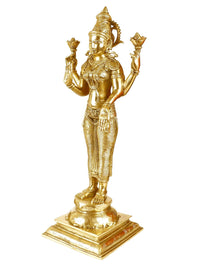 Brass Lakshmi statue, side view, four arms holding symbols, detailed ornaments