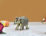 Brass elephant figurine with ornate head and patterned body, full side view