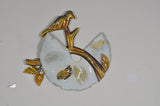 Iron birds on branch wall decor with gold-tone details and round white backplate
