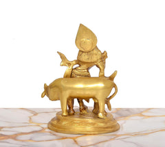 Brass Krishna with flute statue on cow, view from rear showing cow and base