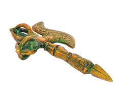 Side view of brass phurba dagger with decorated shaft, green enamel, and pointed tip