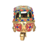 Brass auto rickshaw figurine, front view with red face panels and jeweled trim