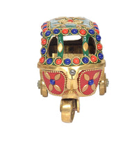 Brass auto rickshaw figurine, front view with red face panels and jeweled trim