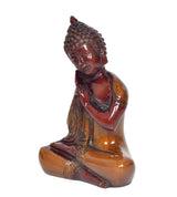 Brass Buddha statue seated in meditation pose with ornate robes