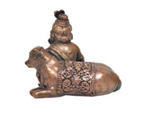 Copper Bal Gopal idol from back side with cow figure, engraved belt detail